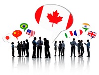 Silhouettes Of Business People Having A Discussion With Each Other And Speech Bubbles With Different National Flags Above Them.