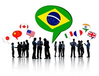 Silhouettes Of Business People Having A Discussion With Each Other And Speech Bubbles With Different National Flags Above Them.