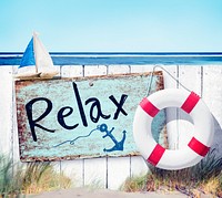 Wooden Fence and Relax Sign Board on Beach