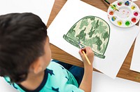 Child with a drawing of soldier helmet