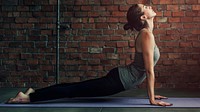 Woman stretching on a yoga mat wallpaper