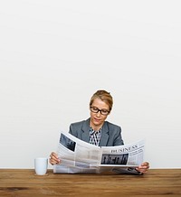 Businesswoman Reading Newspaper For Information