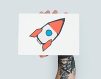 Hand holding placard with rocket start up icon