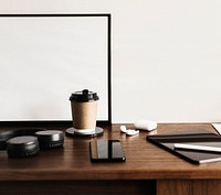 Coffee cup and a digital tablet on a wooden desk