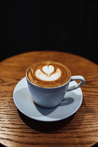Latte art on wooden table vector