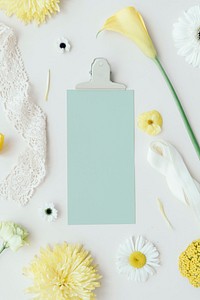 Blue card with white and yellow flowers