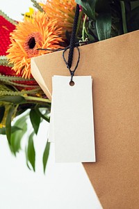 Fresh colorful flowers in a brown bag with a card