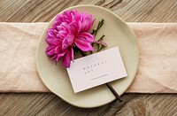 Pink dahlia Flower on a beige plate with a card