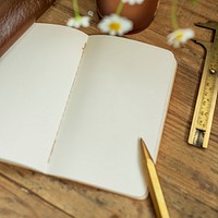 Blank notebook with a golden pencil
