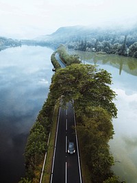 Driving along the road on a lake drone shot