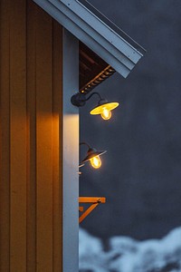 Outdoor lamp on a yellow cabin on Lofoten island, Norway 