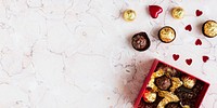 Chocolates on a marble texture background social banner