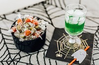 Halloween party with a drink and a bowl of candies on the table