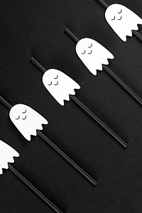 White ghost straws set on a black background design resources