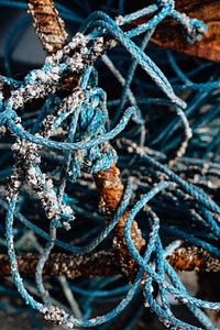 Blue ropes and rusty fishing equipment textured background