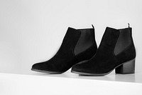 Black ankle boots on a white background