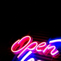 Neon pink open sign on black background