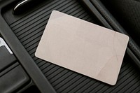 Blank beige business card mockup on a center of car console space