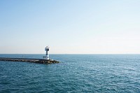 Lighthouse on the blue calm sea