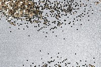 Gold glitter confetti on a silver background 
