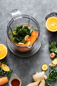 Fresh carrot and kale in a blender food photography