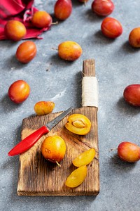 Fresh ripe plums on a cutting board