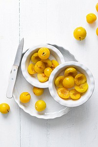 Fresh sliced mirabelle plums in a bowl
