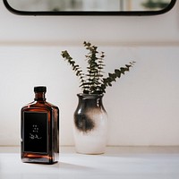 Liquid brown bottle by a vase