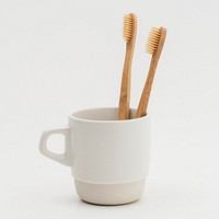 Natural bamboo toothbrushes in a cup
