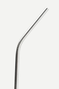 Reusable stainless steel straws on off white background