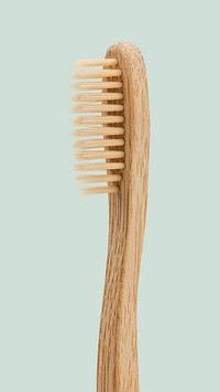 Natural bamboo toothbrush on blue background