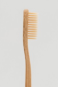Natural bamboo toothbrush on off white background
