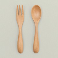 Wooden spoon and fork on off white background