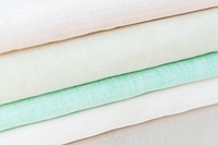 Stack of folded woven fabric patterned background