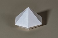 3D silver diamond shaped paper craft on a beige background
