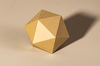 3D golden pentagon shaped paper craft on a beige background