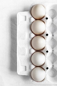 Fresh organic raw eggs in a carton