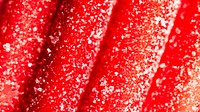 Red chewy candies coated with sugar 