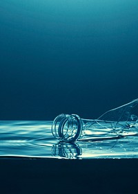 Single use plastic bottle floating in the ocean