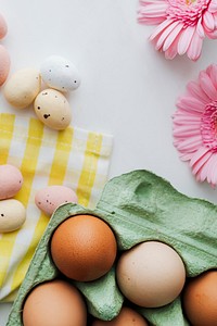 Easter eggs and pink gerbera spring flatlay