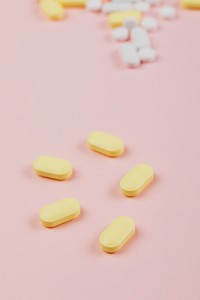 Medicine and pills on a pink background