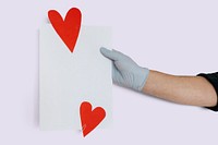 Gloved hand holding a card mockup decorated with red hearts