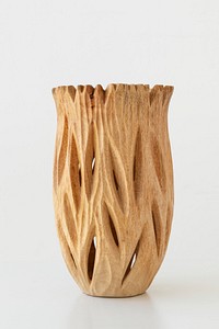Wooden engraved vase on off white background