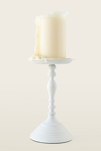 White candle on a plated candlestick