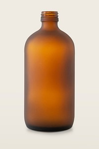 Empty brown glass bottle on off white background