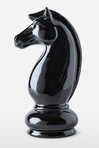 Shiny black knight chess piece on off white background