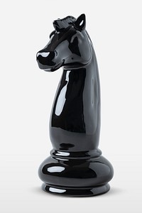 Shiny black knight chess piece on off white background