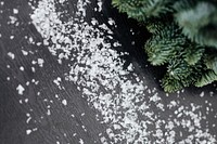 Fresh pine branch and snowflakes on the table