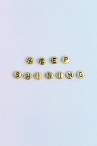 gold KEEP SHINING beads lettering typography on pastel