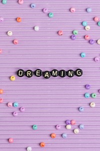 Black DREAMING beads text typography